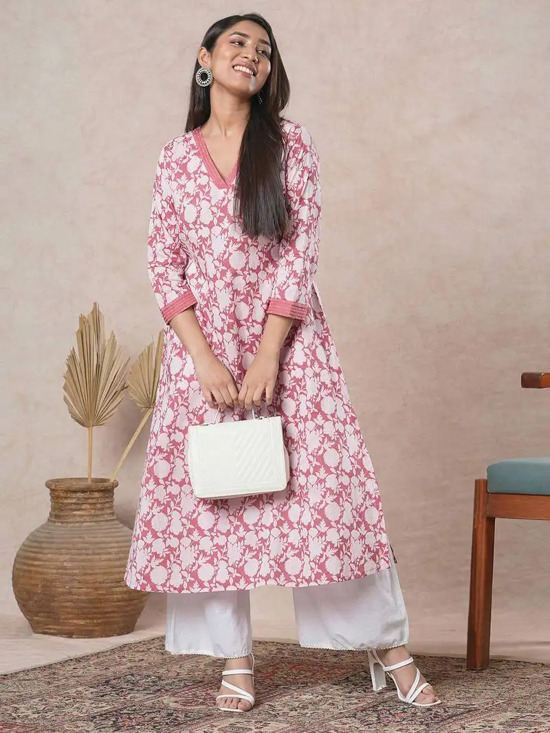 A-line cotton printed kurta with bead detailing around pleated v-neck and sleeve.