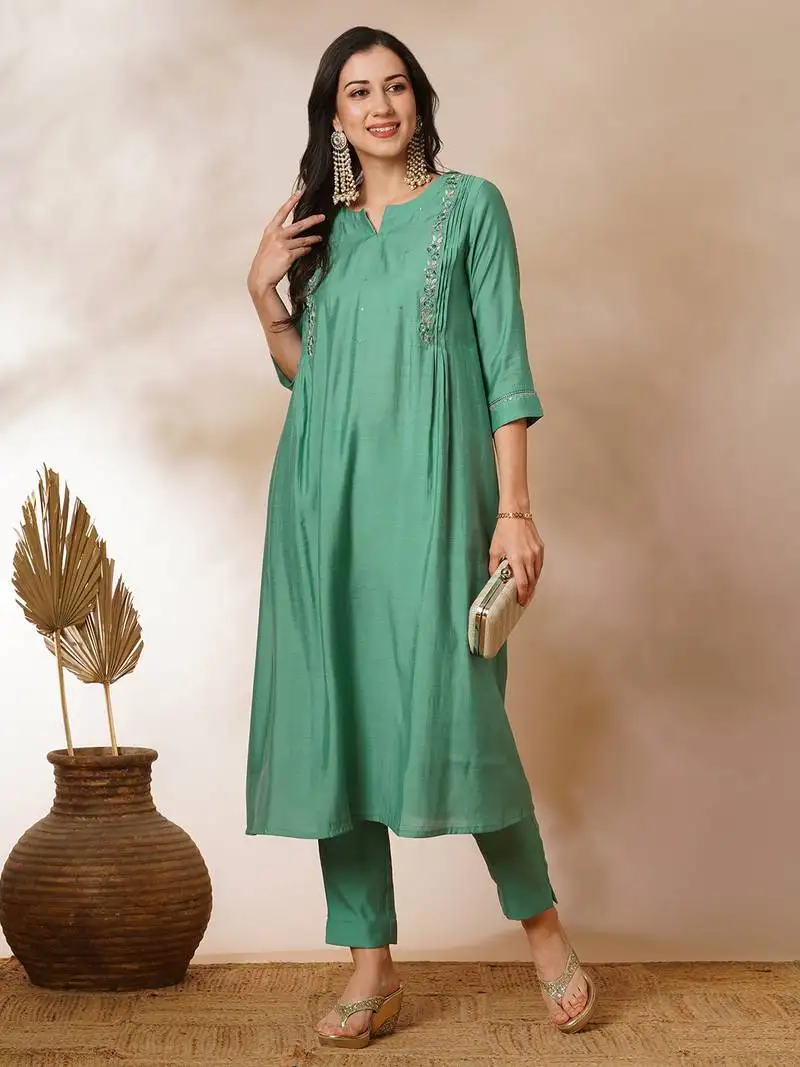 Pleated a-line silk blend kurta with embroidery and pocket, paired with lined silk blend pants.