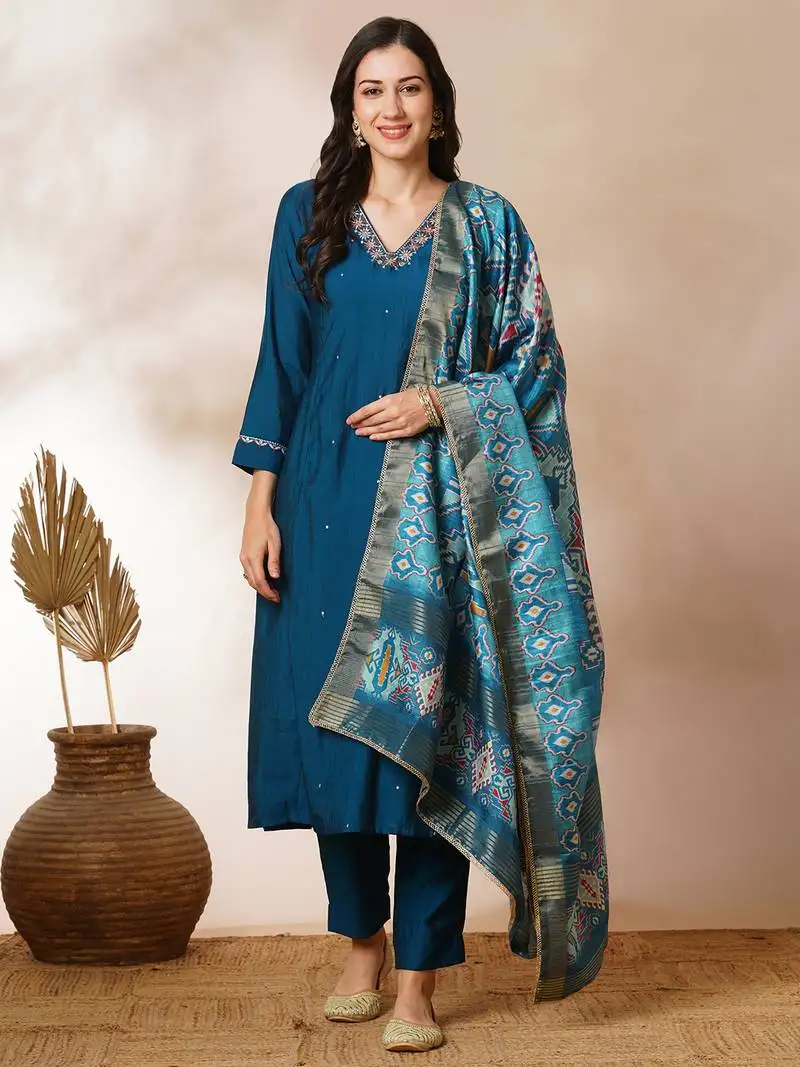 A-line silk blend kurta with zari embroidery detailing paired with printed dupatta and silk blend pants.