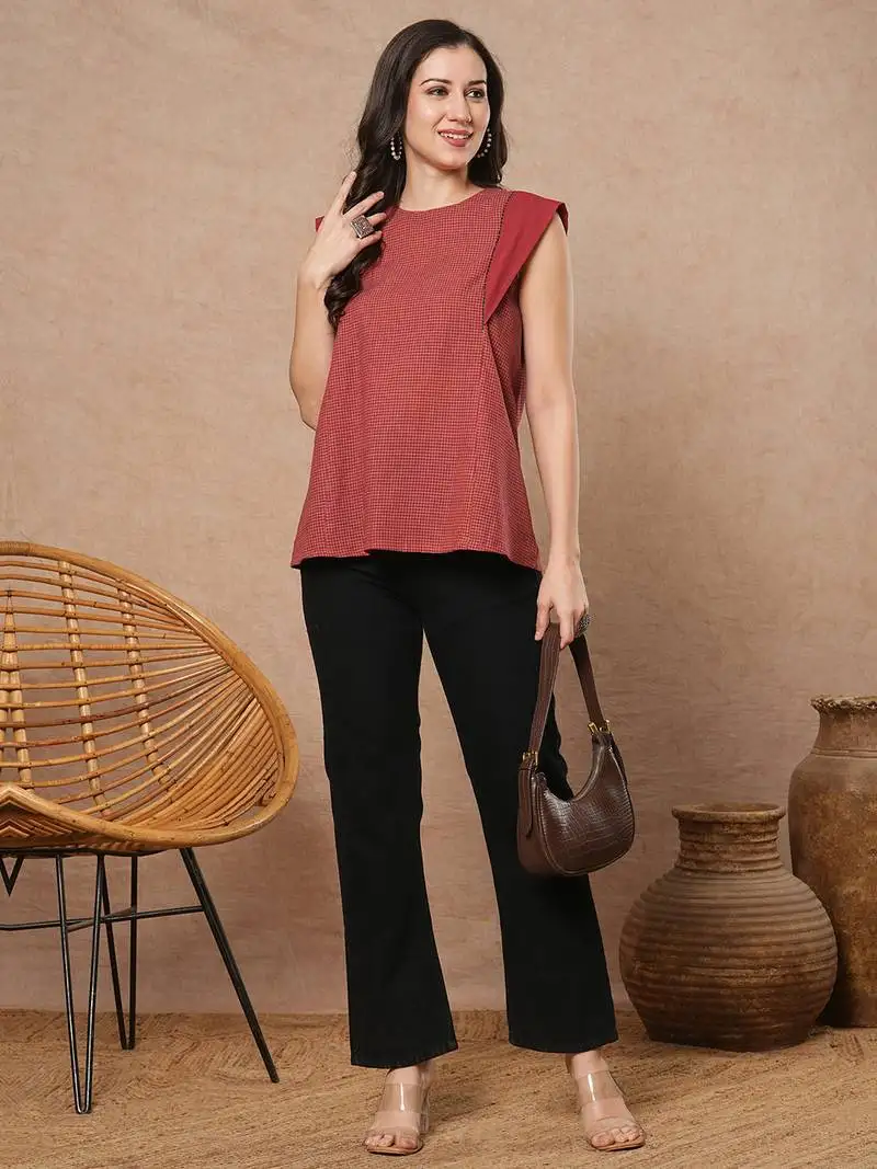 Flared top in chequered cotton fabric with hand embroidered running stitch.