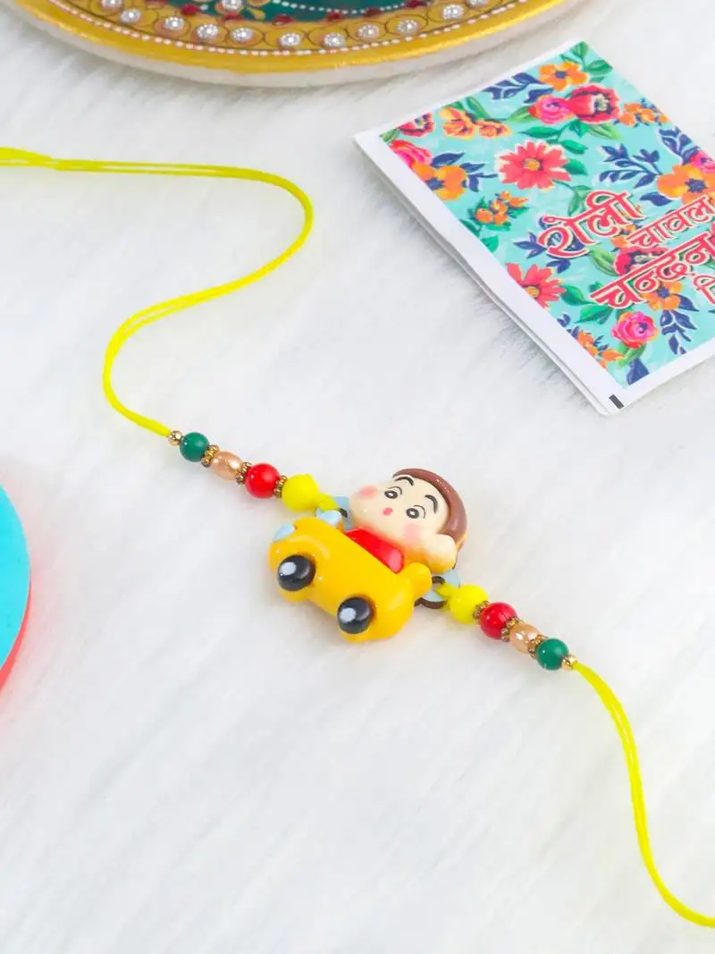 Kids yellow cartoon artificial beads rakhi with roli chawal chandan & mishri